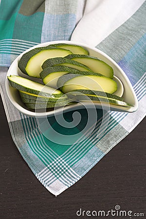 Zucchini sliced â€‹â€‹on green Scottish plaid tablecloth. Stock Photo